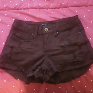 Frayed destroyed maroon denim shorts